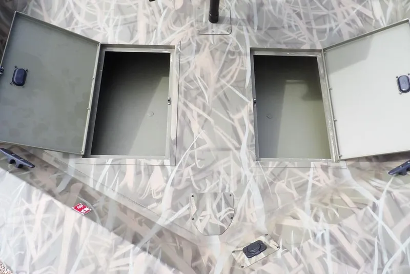 Slide: The Image of 2026 Crestliner 1870 Retriever FCC boat with open storage compartments, camo design. - 24