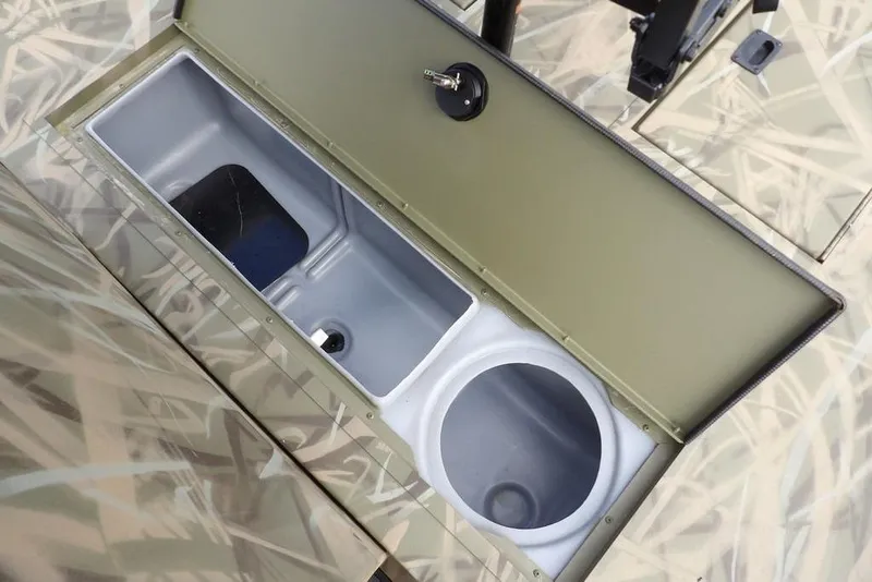 Slide: The Image of 2026 Crestliner 1870 Retriever FCC boat storage compartment with camouflage design. - 25