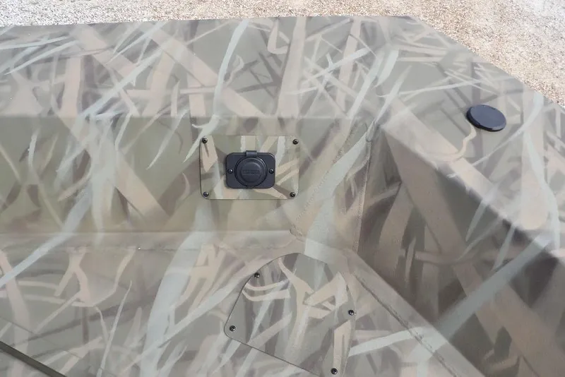 Slide: The Image of 2026 Crestliner 1870 Retriever FCC boat with camouflage pattern and utility features. - 26