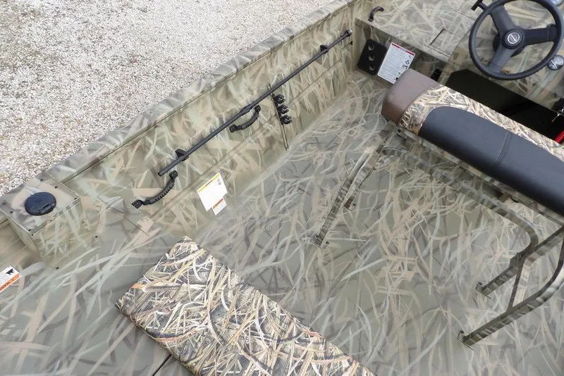 Slide: The Image of 2026 Crestliner 1870 Retriever FCC boat interior with camouflage design and steering wheel. - 8