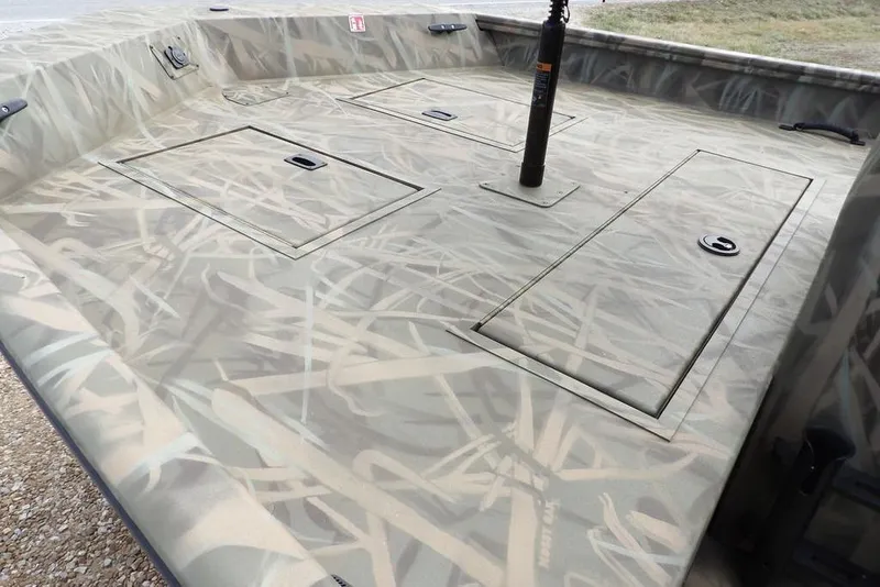 Slide: The Image of 2026 Crestliner 1870 Retriever FCC boat interior with camo design and storage compartments. - 9