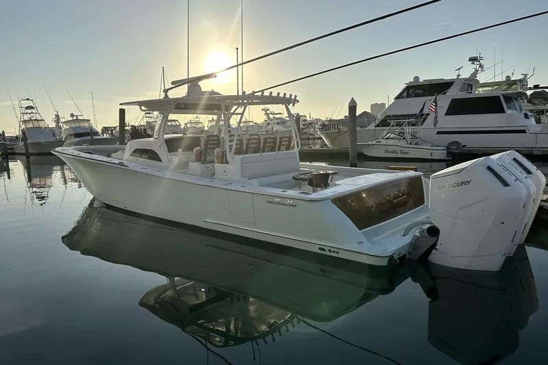 Slide: The Image of 2025 Valhalla Boatworks V-46 docked at marina, sunset reflecting on water. - 17
