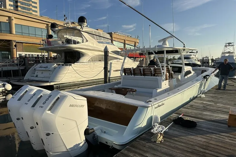 Slide: The Image of 2025 Valhalla Boatworks V-46 docked, featuring powerful Mercury engines, in a marina setting. - 2