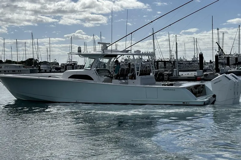 Slide: The Image of 2025 Valhalla Boatworks V-46 in marina, sleek design, powerful engines, calm waters. - 21