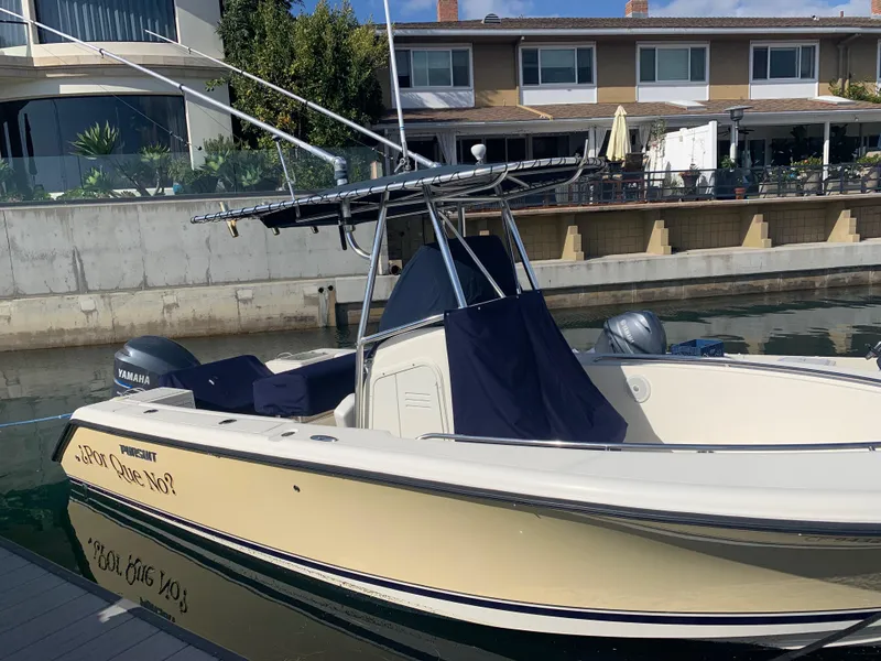 Slide: The Image of 2008 Pursuit C-230 Center Console boat docked near waterfront homes. - 14