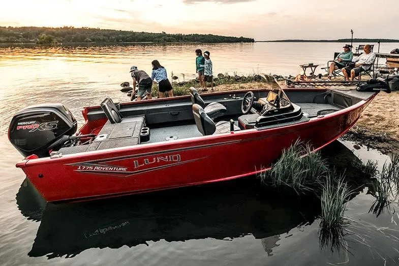 Slide: The Image of Manufacturer Provided Image: 2026 Lund 1775 Adventure SS boat docked by a serene lakeside at sunset. - 5
