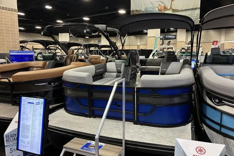 The Image of 2026 Bennington 23 S Swingback pontoon boat displayed at an indoor boat show. - 0
