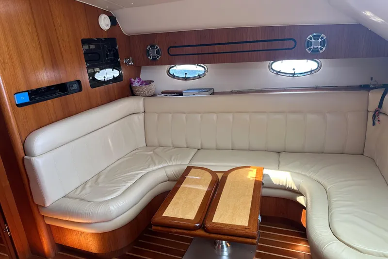 Slide: The Image of Luxurious interior of 2005 Tiara Yachts 3800 Open with white leather seating and wooden accents. - 11