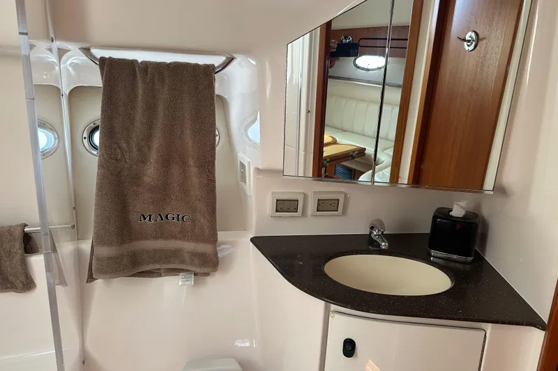 Slide: The Image of Luxurious bathroom in 2005 Tiara Yachts 3800 Open, featuring elegant fixtures and a towel labeled "Magic." - 12