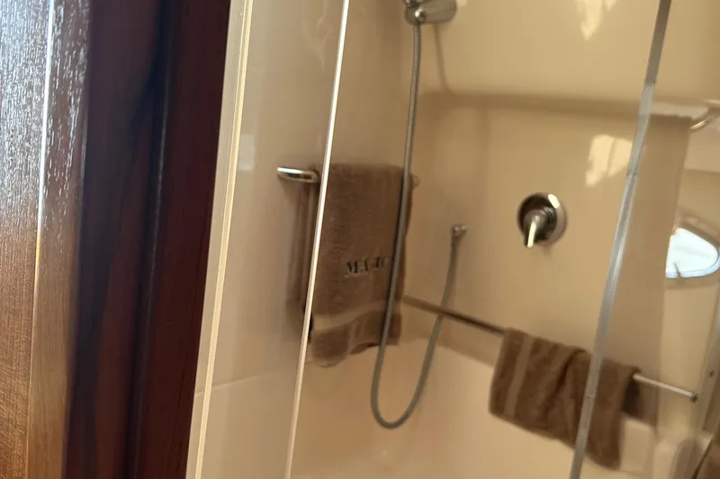 Slide: The Image of Shower area in 2005 Tiara Yachts 3800 Open, featuring towels and modern fixtures. - 13