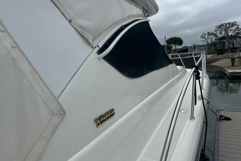 Slide: The Image of 2005 Tiara Yachts 3800 Open docked, showcasing sleek design and branding. - 17