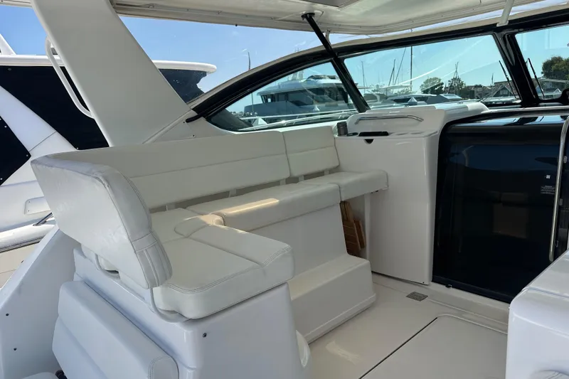 Slide: The Image of 2005 Tiara Yachts 3800 Open interior with white seating and sleek design. - 4
