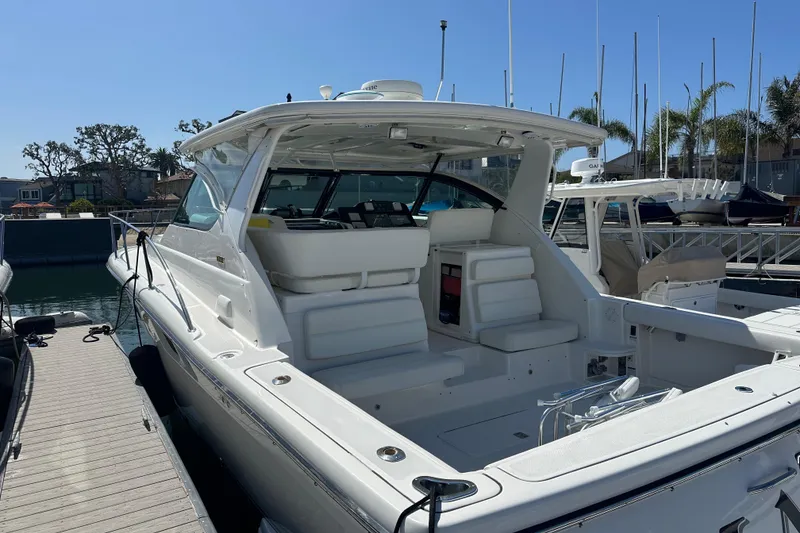 Slide: The Image of 2005 Tiara Yachts 3800 Open docked, showcasing spacious deck and sleek design. - 5