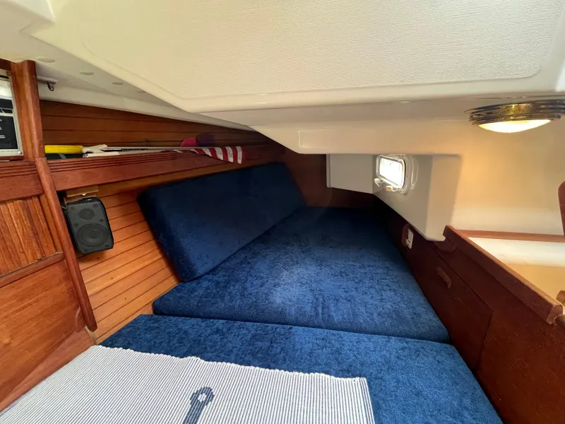 Slide: The Image of Interior of a 1988 Sabre 34 MK II yacht with blue cushions. - 16