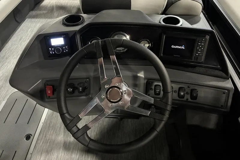 Slide: The Image of 2026 Bennington S Quad Bench 22 SSR SPS boat dashboard with Garmin display and controls. - 5