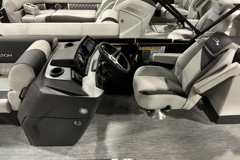Slide: The Image of 2026 Bennington S Quad Bench 22 SSR SPS boat interior with modern helm and seating. - 4