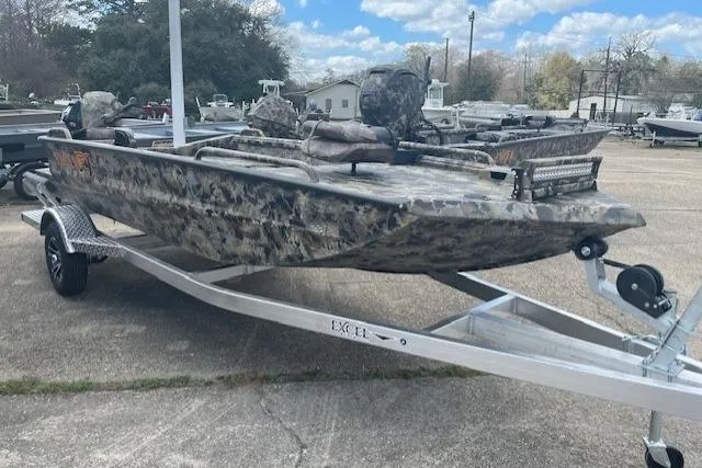 Slide: The Image of 2026 Excel 1751 Viper F4 boat with camouflage design on a trailer, parked outdoors. - 8
