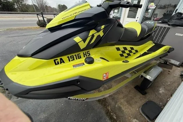 Slide: The Image of 2023 Yamaha WaveRunner VX Cruiser HO in vibrant yellow and black, parked outdoors. - 3