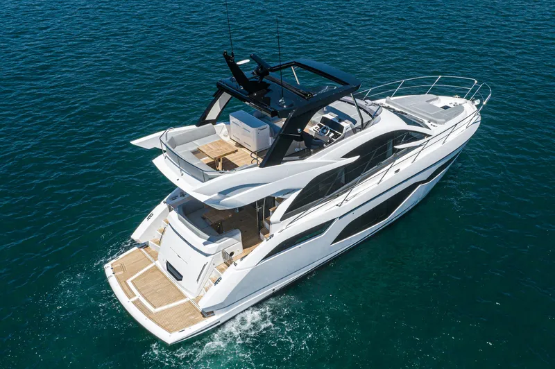 Slide: The Image of 2021 Sunseeker Manhattan 55 luxury yacht cruising on open water. - 2