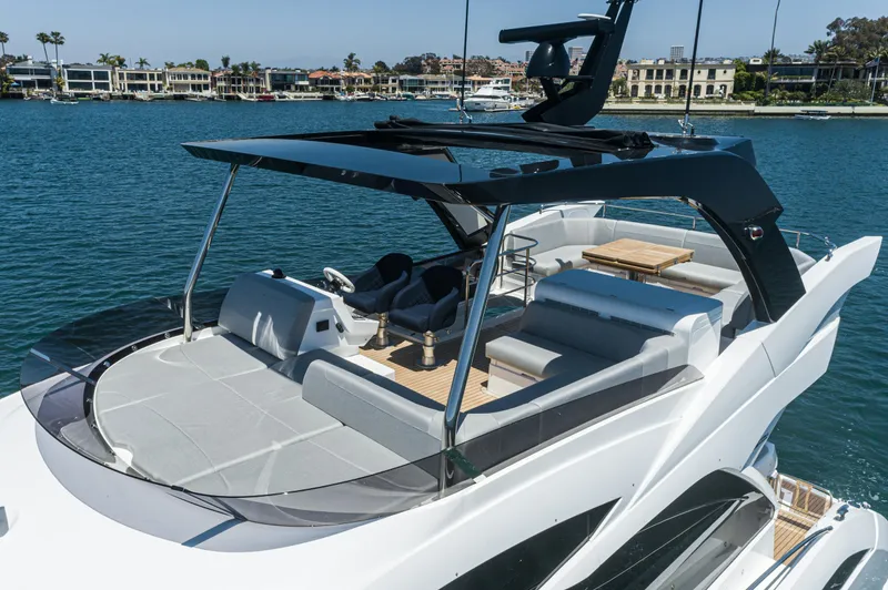 Slide: The Image of Sunseeker Manhattan 55 2021 yacht with spacious deck and seating area on the water. - 27