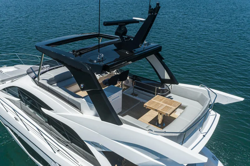 Slide: The Image of 2021 Sunseeker Manhattan 55 luxury yacht on open water. - 28