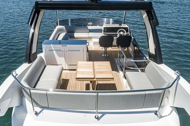 Slide: The Image of 2021 Sunseeker Manhattan 55 yacht deck with seating and helm station. - 29
