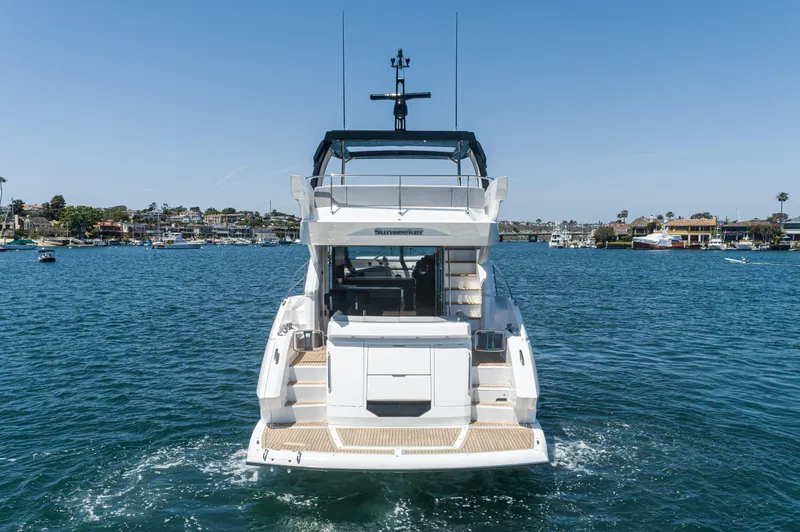 Slide: The Image of 2021 Sunseeker Manhattan 55 yacht on water, rear view. - 3