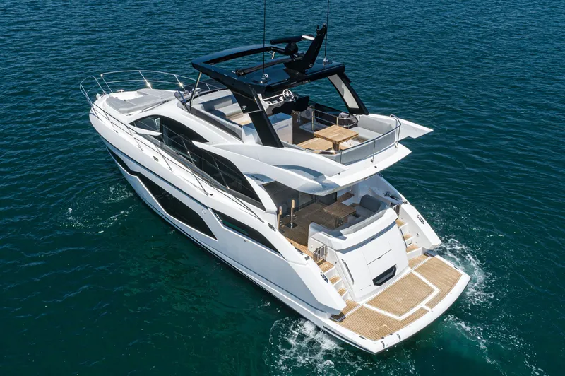 Slide: The Image of 2021 Sunseeker Manhattan 55 luxury yacht cruising on open water. - 34
