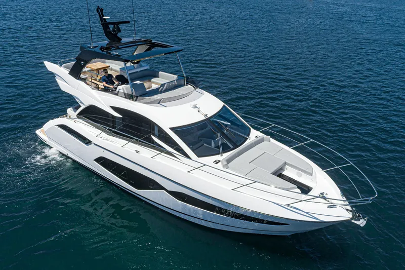 Slide: The Image of 2021 Sunseeker Manhattan 55 luxury yacht cruising on open water. - 37