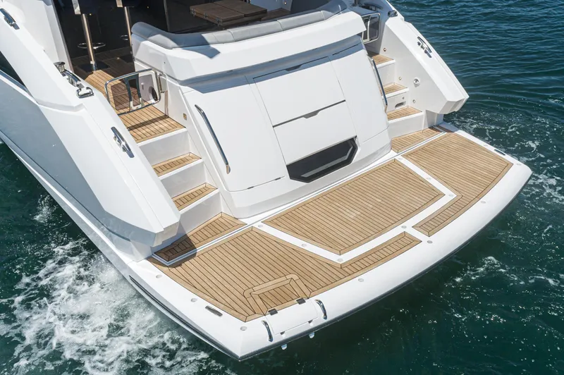 Slide: The Image of Sunseeker Manhattan 55 2021 yacht stern view with teak swim platform. - 4