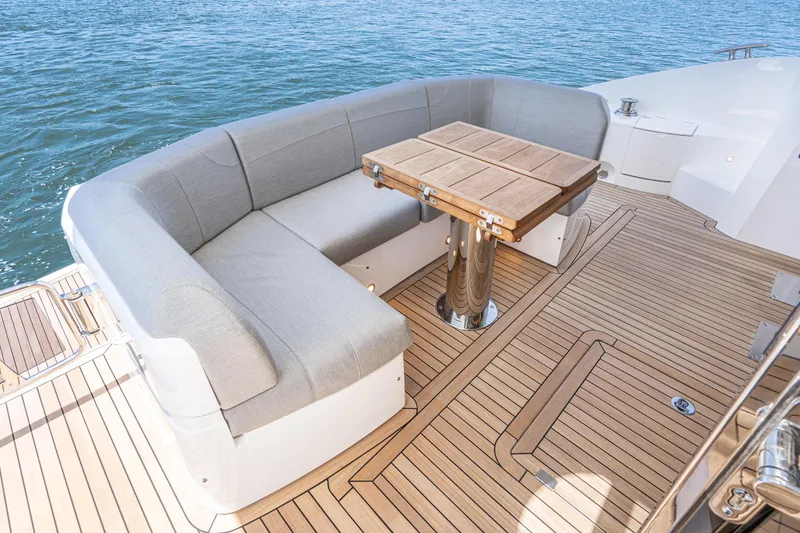 Slide: The Image of Sunseeker Manhattan 55 2021 yacht with teak deck and cushioned seating area. - 7