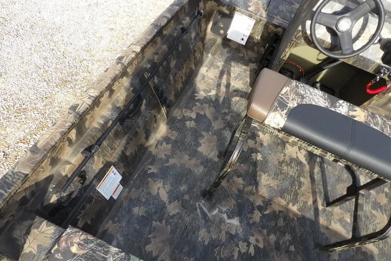 Slide: The Image of 2026 Crestliner 1870 Retriever FCC interior with camouflage design and steering console. - 16