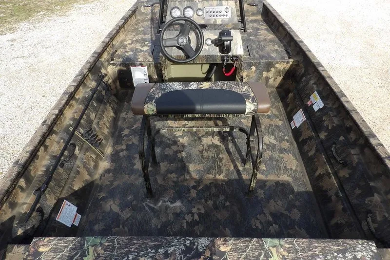 Slide: The Image of 2026 Crestliner 1870 Retriever FCC boat interior with camouflage design and steering console. - 18