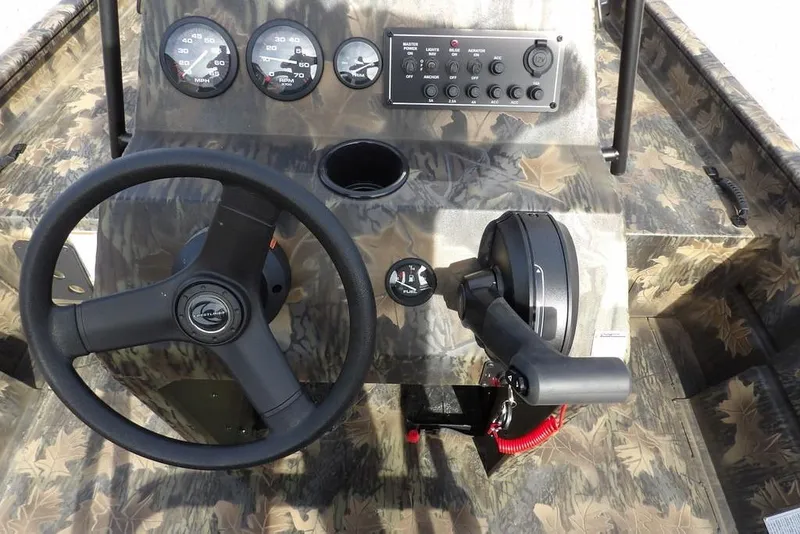Slide: The Image of 2026 Crestliner 1870 Retriever FCC boat dashboard with camo design, steering wheel, and control panel. - 19