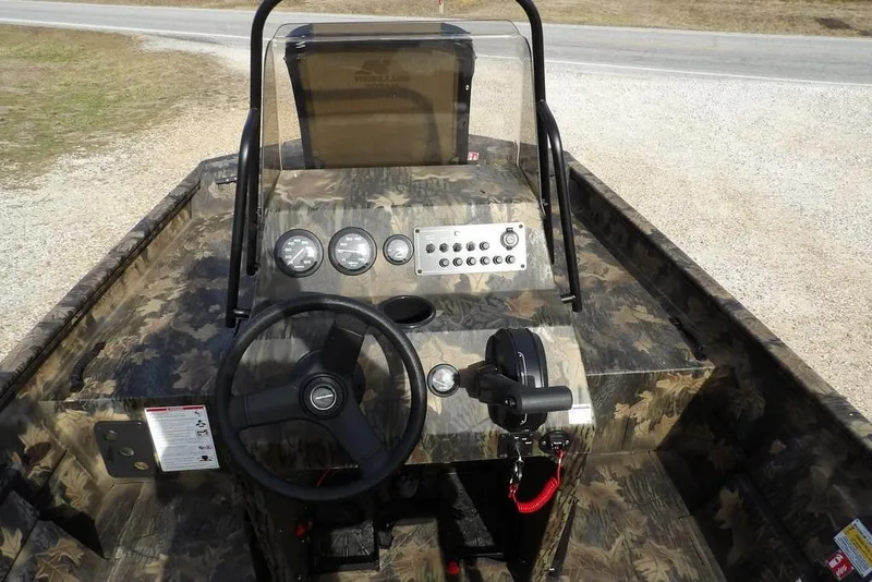 Slide: The Image of 2026 Crestliner 1870 Retriever FCC boat interior with camouflage design and control panel. - 20