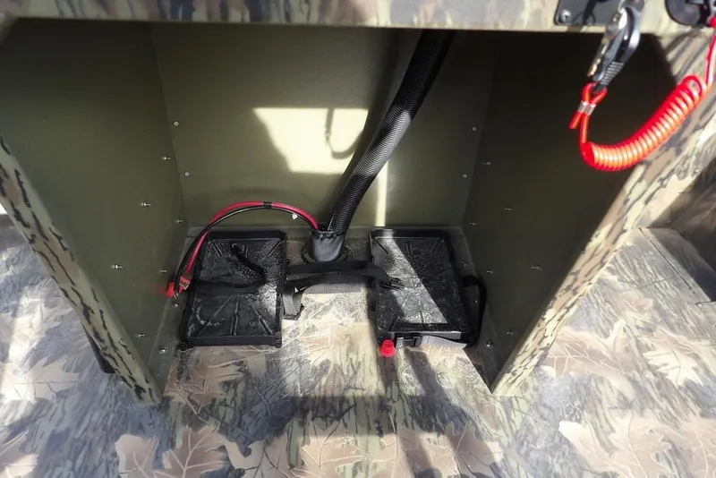 Slide: The Image of Interior view of 2026 Crestliner 1870 Retriever FCC boat with wiring and camouflage design. - 21