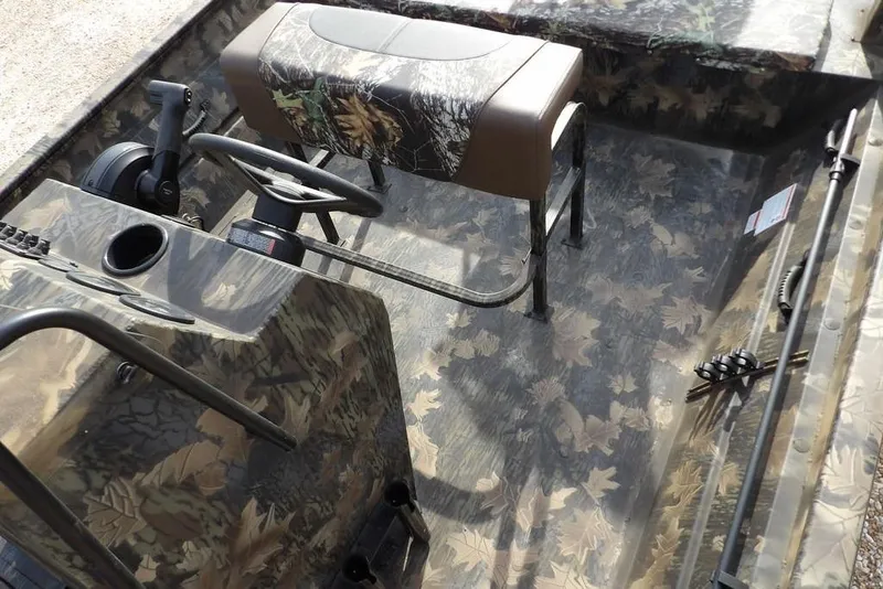 Slide: The Image of 2026 Crestliner 1870 Retriever FCC boat interior with camouflage design and steering console. - 22