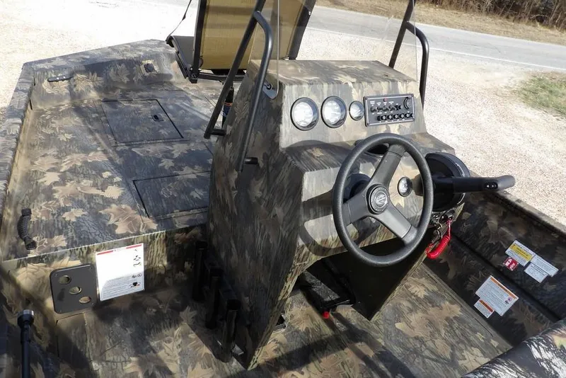 Slide: The Image of 2026 Crestliner 1870 Retriever FCC boat interior with camouflage design and steering console. - 23