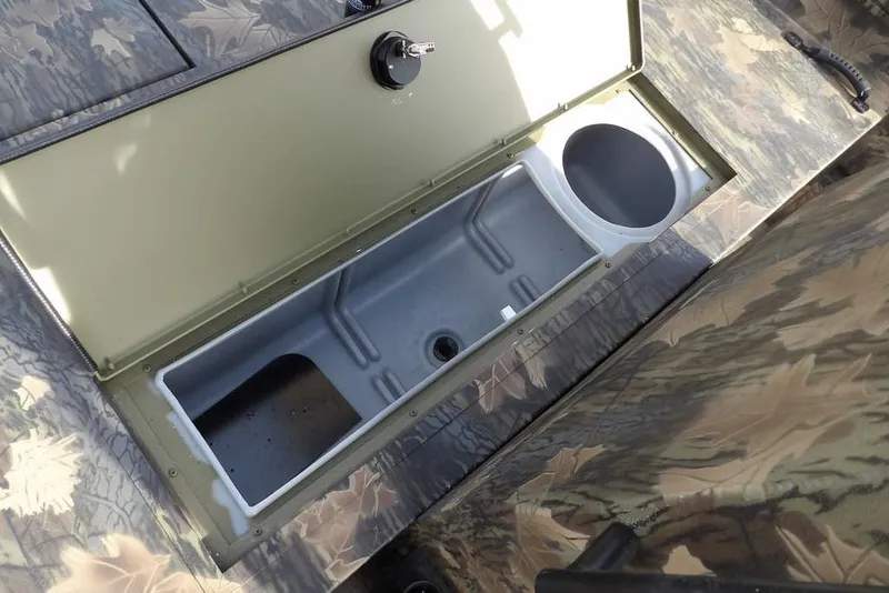 Slide: The Image of Crestliner 1870 Retriever FCC 2026 boat storage compartment with camouflage design. - 26