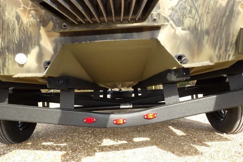 Slide: The Image of 2026 Crestliner 1870 Retriever FCC boat trailer with camouflage design and red lights. - 30