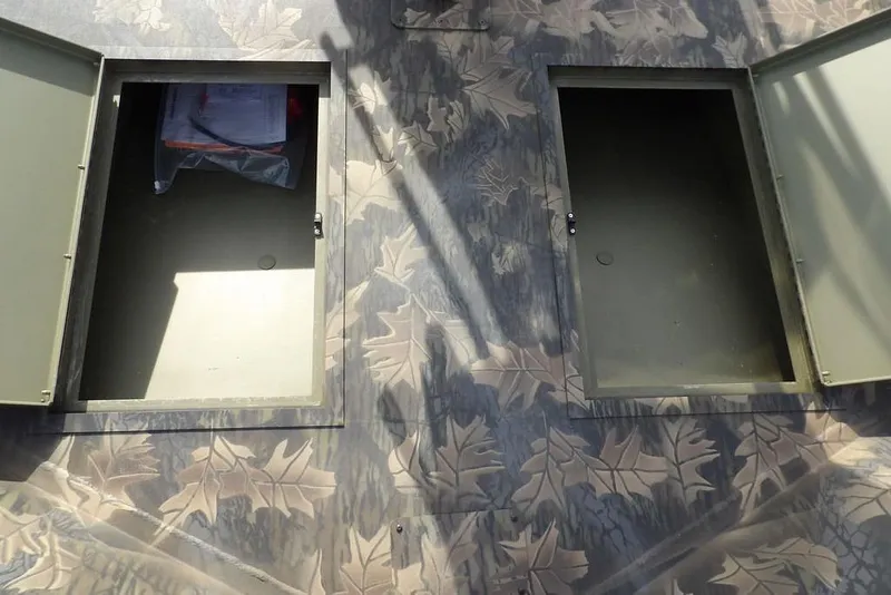 Slide: The Image of Crestliner 1870 Retriever FCC 2026 boat storage compartments with camouflage leaf pattern. - 32