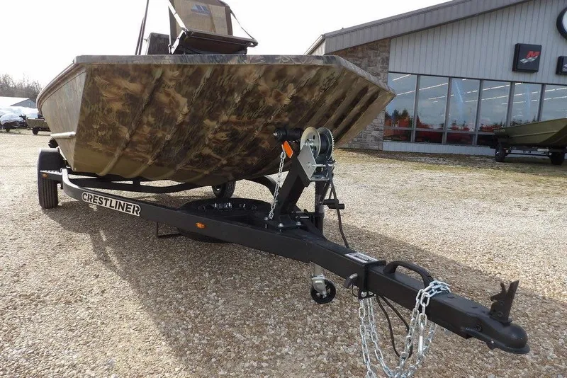 Slide: The Image of 2026 Crestliner 1870 Retriever FCC boat on trailer, camo design, parked outside dealership. - 36