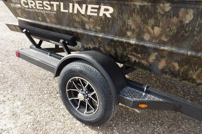 Slide: The Image of 2026 Crestliner 1870 Retriever FCC boat trailer with camouflage design and heavy-duty tire. - 38
