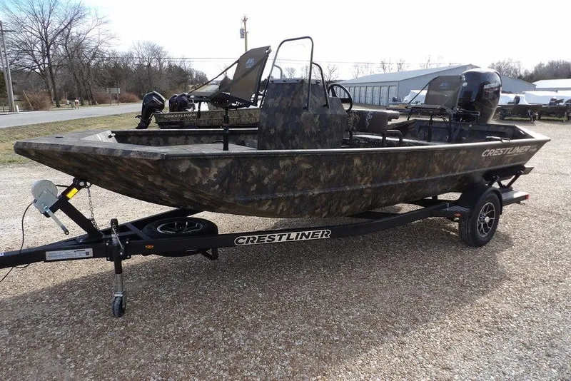 Slide: The Image of 2026 Crestliner 1870 Retriever FCC boat on trailer, camo design, parked outdoors. - 4