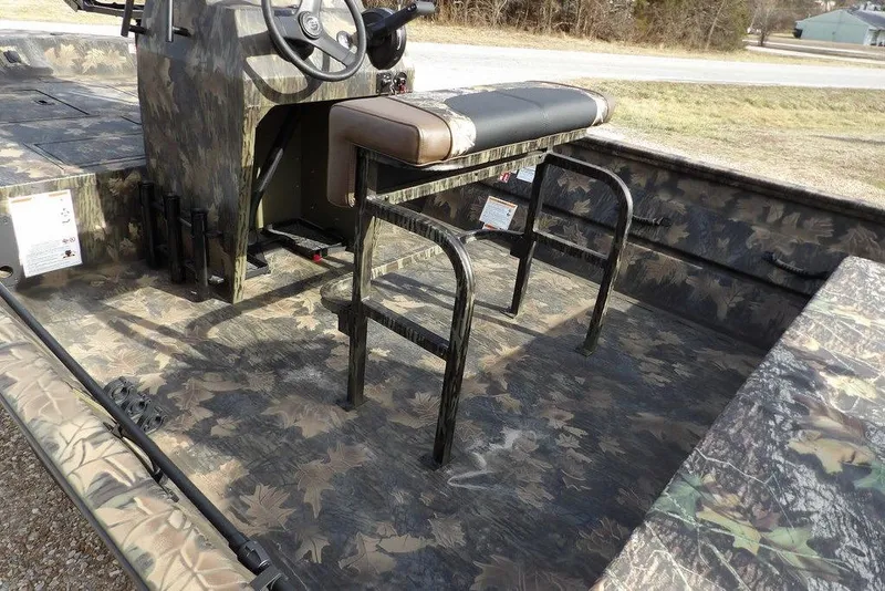 Slide: The Image of 2026 Crestliner 1870 Retriever FCC boat interior with camouflage design and seating. - 7