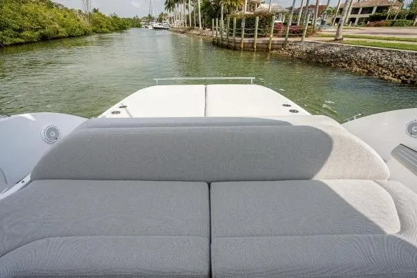 Slide: The Image of 2022 Azimut Atlantis 45 yacht with spacious deck, cruising through a scenic waterway. - 22