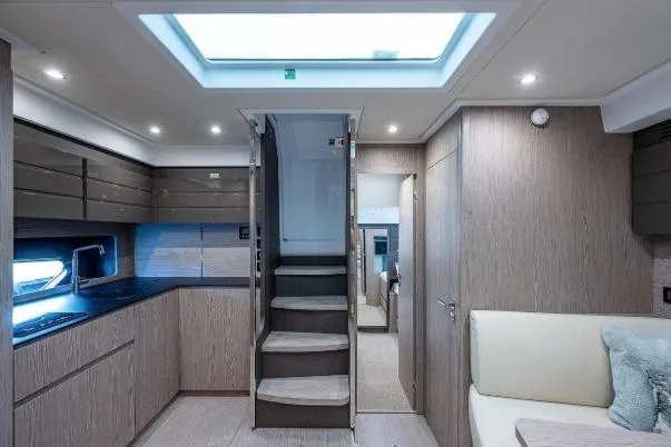 Slide: The Image of Luxurious interior of 2022 Azimut Atlantis 45 yacht, featuring modern kitchen and cozy seating area. - 25