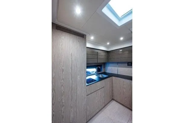Slide: The Image of Modern kitchen interior of 2022 Azimut Atlantis 45 yacht with sleek cabinetry and skylight. - 27