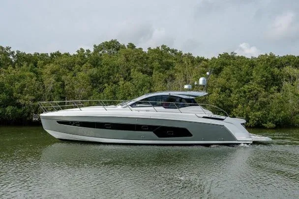 Slide: The Image of 2022 Azimut Atlantis 45 yacht cruising on a serene river with lush greenery. - 3