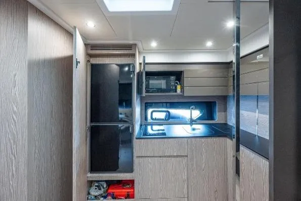 Slide: The Image of Modern kitchen interior of 2022 Azimut Atlantis 45 yacht, featuring sleek cabinetry and appliances. - 30